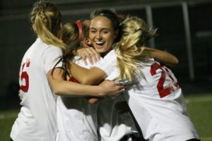 Fiona Samodurov celebrates with her teammates after delivering the goal that helped the Camas girls soccer team defeat Union 1-0 for the league championship Oct. 27, at Doc Harris Stadium.