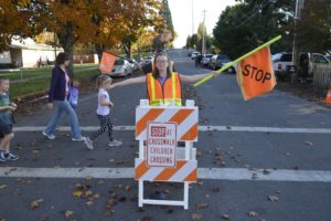 Caitlyn Bailey helps students and parents safely cross the street at Gause Elementary School. 