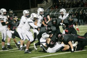 Four Papermakers bring down the ball handler for Skyview Saturday, at Doc Harris Stadium. Camas weathered the Storm, and emerged with a 29-22 victory in the first round of the state tournament.