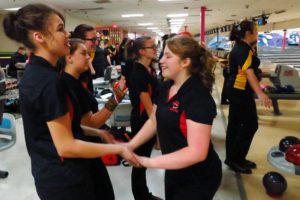 Shelby Chartrand celebrates a strike with Camas bowlers Ariel Laycock, Jaelyn Montoya, Leah Aspinwall and Courtney Warta Wednesday, at Crosley Lanes in Vancouver.