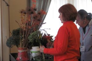 Mary Ann Stevan and Nacy Maser (front) peruse some of the choices for Thanksgiving arrangements during a recent Garden Club meeting. The club is one of several organizations that is hosting holiday themed decorating events.                                