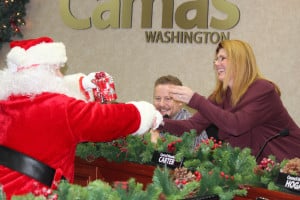 Santa Claus handed out gifts to City Council members including Tim Hazen (left) and Bonnie Carter (right). 