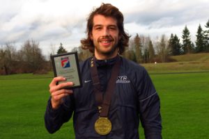 Spencer Head shows off his eighth place plaque and All-American medal earned at the NAIA Cross Country National Championship. The 25-year-old from Camas runs for Dalton State College, in Dalton, Georgia.