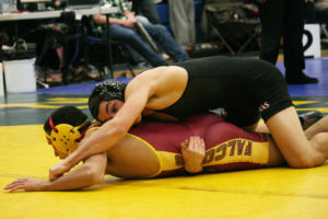 Camas wrestler Rylan Thompson keeps Prairie's Kodi Walls on the mat during his 132-pound semifinal match at the Pacific Coast Championships Saturday, at Mountain View High School. Thompson won 5-3 to reach the championship round and finish in second place.