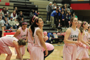 Camas High School varsity basketball players toss pink balls into the crowd during Hoops for Pink on Friday. The event was a fundraiser for the Kay Yow Cancer Fund. (Heather Acheson/Post-Record)