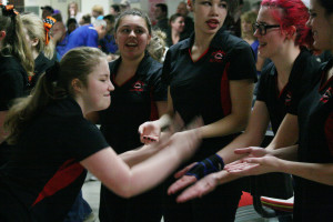 Shelby Chartrand (left) celebrates with her teammates during the district meet Friday. 