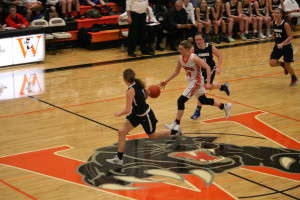 RaeAnn Allen breaks free from the swarming Hockinson Hawks Monday, at Washougal High School. The Hawks took advantage of several turnovers and soared to a 53-42 victory.