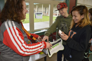 Wendy Butler, a student assistance counselor from Educational Service District 112, hands out drug and alcohol fact sheets to students at Canyon Creek Middle School. The event was a part of National Drug and Alcohol Facts Week. (Contributed photo)