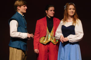 Prince Eric (Carson Connors) is about to propose to Ariel (Sydney Valaer), while Sebastian the Crab (Keira Stogin) looks on.