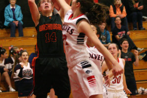 RaeAnn Allen (14) scores two points for the Washougal girls basketball team against Black Hills Monday, at R.A. Long High School, in Longview. The Wolves defeated the Panthers 49-44 in the semifinals of the district tournament.