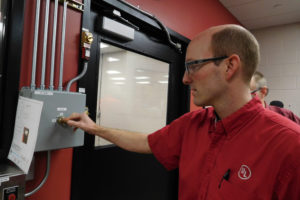 Lab manager Jody Brittenham performs safety protocols before demonstrating product testing at UL's new short circuit lab. 