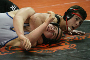 Dylan Ingram holds Calhoun Helberger, of Curtis, down for the second time in the 4A state wrestling tournament Saturday, in the Tacoma Dome. Ingram won 4-0 and brought home a third-place medal.