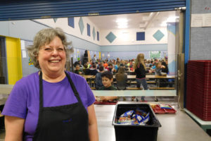 Sandy Bell has been working in food service for the Washougal School District for 10 years. Here, she serves students at Gause Elementary School.