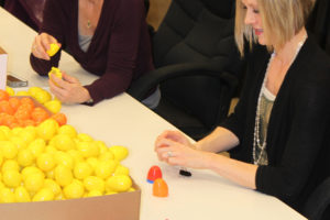 Rene Carroll (left) and Courtney Wilkinson (right) fill plastic eggs with candy in preparation for Wednesday's EGGstravaganza event at Reflection Plaza in downtown Washougal. Wilkinson said the Downtown Washougal Association decided to plan an Easter activity after special events for Halloween and Christmas proved popular with local residents. 