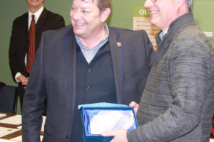 Chad Sessions presents volunteer Randy Curtis (right) with a "Real Hero" award during a Washougal School District board meeting recently. (Contributed photo)