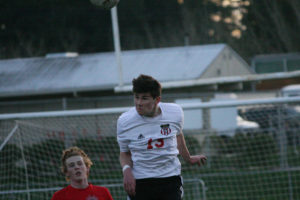 Dominic Fewel chips the ball out of the back for the Camas High School boys soccer team Friday, at Doc Harris Stadium. The sophomore used his head to score the first of three goals for the Papermakers against Archbishop Murphy.