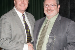 Eric V. King receives a Bonneville Power Administration 2016 Administrator's Excellence Award from Administrator Elliot Mainzer during a ceremony in March in Portland. (Contributed photo)