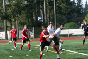 Bennett Lehner and Danny Wing keep an eye on Erik Brainard as he battles a Titan for the soccer ball Friday, at McKenzie Stadium. These three Papermakers connected on two goals to help Camas defeat Union 2-0. 