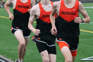 Gabriel Dinnel, Tanner Lees and Aiden Pullen push each other to the finish line May 3, at Fishback Stadium. The Panthers earned first, second and third place in all three distance races to help the Washougal boys track and field team beat Woodland for the league championship. 