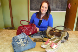 Amanda Van Kregten displays examples of name brand shoes, handbags and jeans that she plans to sell at Pippilottas Consignment. The new business will accept clothing and accessories for young adults  Friday, June 3, from 5 to 8 p.m., at Journey Community Church, 304 N.E. Fourth Ave., Camas. Pippilottas Consignment will open Friday, July 1, at the current location of Lil' Dudes and Divas, 411 N.E. Dallas St., Camas.