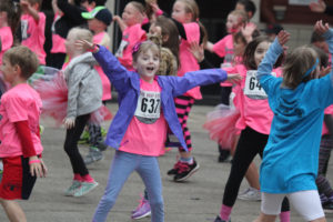 Jenny Thurman (637) joins more than 50 other first-graders as they do jumping jacks to warm up for their 1.5K race, held during Saturday's Stride for Education. The fundraising event for the Washougal Schools Foundation included eight walking and running races for kindergartners to adults. A free quarter-mile Kitty Dash, for kids ages 5 and younger, finished off day's events. (Heather Acheson/Post-Record)