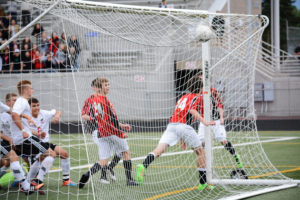 Toby Pizot (8) ends this scramble by kicking the soccer ball into the net Wednesday, at Doc Harris Stadium. Camas tied the score on this goal, but lost to Snohomish 2-1. 