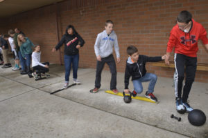 One of the favorite team building exercises Jemtegaard Middle School students participated in was led by parents Traci and Tom Stinchfield. Students were asked to work as a team to get a variety of heavy objects and each other from one point to another, using the objects as stepping stones and not letting their feet hit the ground. (Contributed photo)