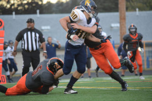 Kade Coons (left) and Jacob Sonneman key in on a tackle for Washougal Friday, at Fishback Stadium.