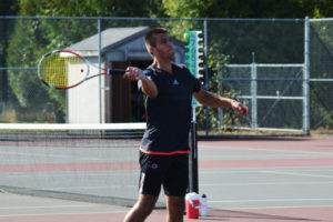 Sam Christopher smashes the tennis ball to score a point for the Papermakers against Washougal Friday, at Camas High School. 