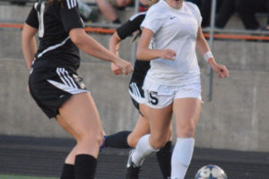 Katie Boon senses goal for the Washougal girls soccer team Thursday, at Fishback Stadium. The junior midfielder delivered a cross that led to a score and then a 30-yard strike of her own to help the Panthers defeat Woodland 3-0.