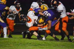 Washougal's Nathan Tofell and Tyler Bowlin bring down the River running back Friday, at Columbia River High School. 