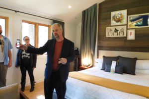 Ron Mitchell, principal architect with MG2 of Seattle, shows open house attendees a photo of an outdoor bathtub at a treehouse he built recently. The units at Skamania Lodge do not currently have this option. 