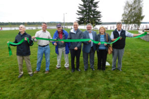 Port of Camas-Washougal Commissioners Bill Macrae-Smith, John Spencer and Bill Ward, along with Port Executive Director David Ripp, Washougal Mayor Sean Guard, Washington State Department of Ecology Regional Section Manager of the Toxics Cleanup Program Rebecca Lawson and Maul Foster Alongi President Jim Maul (left to right) cut a ribbon signaling the official opening of Washougal Waterfront Park and Trail. A ceremony was held Sept. 23, at the former Hambleton Lumber Company property at 335 S. "A" St., Washougal. 