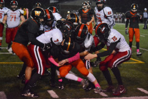 Kade Coons fights for more yards for the Washougal High School football team Friday, at Fishback Stadium. The Panthers defeated R.A. Long 27-19 to secure a playoff spot for the first time since 2007. 