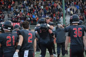 Vinny Gennaro jumps into the arms of Caleb Eldred after the Camas High School football team beat Sumner 45-21 in the semifinals of the 4A state tournament Saturday, at McKenzie Stadium in Vancouver.