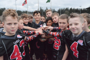 Eighteen Camas Jets hold a piece of the Pacific Northwest Region championship trophy, which they won at Doc Harris Stadium Nov. 20. These 10- and 11-year-olds from Camas and Washougal will play in the Pop Warner Super Bowl Dec. 3 to 10, in Orlando.