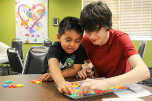 A volunteer with Project Transformation uses magnetic letters to interact with a child. The goal of the eight-week program is to close the reading gap for children who need extra help. Camas United Methodist Church will participate in Project Transformation in 2017. (Photo contributed by Project Transformation National)