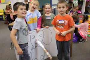 First-grade students at Gause Elementary proudly display their project about how to make a prosthetic trunk for an elephant. It was inspried after the class read a series of books about animals who have faced challenges. (Contributed photo)