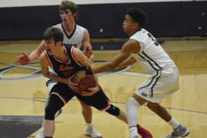 Alex Glikbarg hangs on to the basketball for Camas against two Skyview defenders Tuesday. Glikbarg scored 16 points for the Papermakers, but the Storm won the game 48-40. 