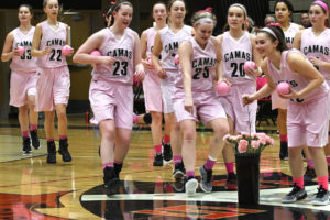 The Camas High School girls basketball players pick up pink roses to give to breast cancer survivors in the crowd before Friday night's game against Heritage. The Papermakers won 74-18. (Photos courtesy of Kris Cavin)