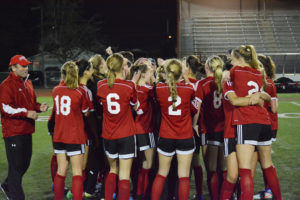 The Camas High School girls soccer team, and head coach Roland Minder (left), celebrate winning the 4A state championship Nov. 19, at Sparks Stadium, in Puyallup. The Papermakers finished No. 1 in the MaxPreps National Rankings. Minder earned National Coach of the Year honors from the National Soccer Coaches Association of America. 