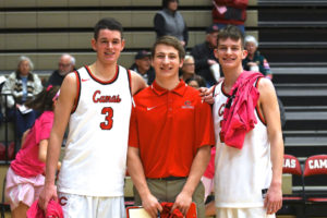 Jake Hansel (center) stands with friends Tanner Fogle and Alex Glikbarg after a basketball game, at Camas High School. Hansel is working on a fundraiser to raise awareness for hypertrophic cardiomyopathy, a heart condition that forced him to give up basketball before his senior year of high school. (Photo courtesy of Kris Cavin)