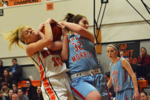 Toryi Midland (10) rips the basketball away from Libby Bartleson to get the rebound for Washougal Monday. The Panthers beat Mark Morris 46-40 to remain in first place in league.