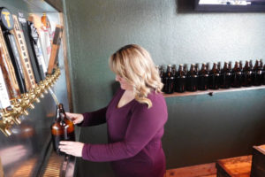 Jeannine Mills fills a customer's growler with Pfriem Winter Ale, of Hood River, Ore. Mills, owner of Washougal Fill Station, has 10 beers and two hard ciders on tap, including local brews. 