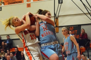 Toryi Midland (10) rips the rebound away from a Monarch Monday, at Washougal High School. The Panthers defeated Mark Morris 46-40 to remain standing all alone in first place in league. 