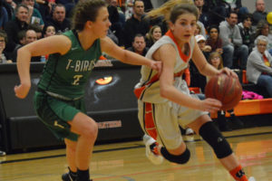 Mason Oberg (right) drives to the hoop and scores two of her 33 points Feb. 10, at Washougal High School. The Panthers beat Tumwater 59-45 in the first round of the 2A district tournament. 