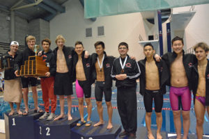 Camas High School swimmers Luke Albert, Jeff Fadlovich, Tom Utas, Finn McClone, Mark Kim, Chris Xia, Brian Andrade, Jaden Kim, Eric Wu and Austin Fogel stand on the podium as 4A state champions Saturday, at the King County Aquatic Center in Federal Way.