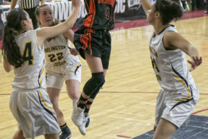 Washougal guard Mason Oberg (4), floats a two point score over Burlington-Edison's Jazzlyn Woods (34), right, during the second round of the WIAA 2A girls state tournament, March 2, at the Yakima Valley Sun Dome. The Burlington-Edison Tigers defeated the Washougal Panthers 58-55. 