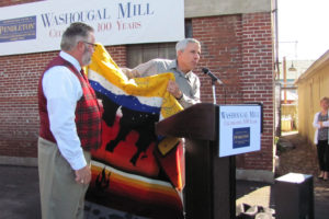 During a centennial celebration at Pendleton Woolen Mills in August 2012, Charlie Bishop, executive vice president of manufacturing, presented Washougal Mayor Sean Guard with a ceremonial robe. Bishop plans to leave his job of more than 35 years on Friday.