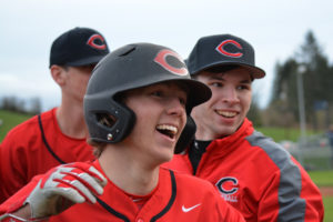 Taylor Adams celebrates with his teammates after delivering the winning hit for the Camas baseball team in extra innings Monday. The Papermakers beat Skyview 6-5 in the bottom of the eighth.